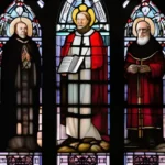 A stained glass window depicting key figures from the Anglican Church. - Anglican Church beliefs