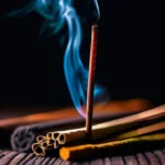 A close-up image of various types of incense sticks arranged artfully against a dark background. - incense in religion