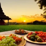 A serene image of a Hindu temple at sunset with a plate of fresh fruits and vegetables in the foreground. - Hindu vegetarianism